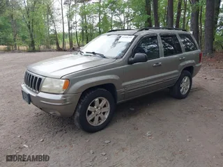 1999 Jeep Grand Cherokee Limited with VIN 1J4GW68N5XC684157, listed as a IAAI auction lot 42104283 with 164,506 mi miles. Bid and sale history available at carsss.com. Image 2.