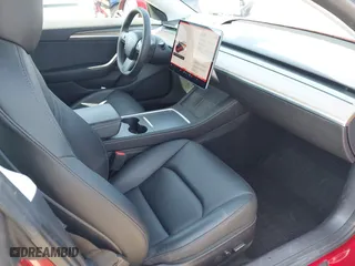 2021 Tesla Model 3 Standard Range Plus with VIN 5YJ3E1EA0MF099562, listed as a IAAI auction lot 41771323 with 26,087 mi miles. Bid and sale history available at carsss.com. Image 5.