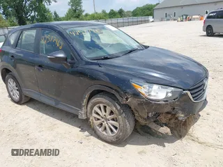 2016 Mazda CX-5 Sport with VIN JM3KE2BY5G0908809, listed as a IAAI auction lot 42577462 with 215,041 mi miles and . Bid and sale history available at DreamBid. Image 1.