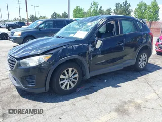 2016 Mazda CX-5 Sport with VIN JM3KE2BY4G0807776, listed as a IAAI auction lot 42206641 with 136,809 mi miles and . Bid and sale history available at DreamBid. Image 2.