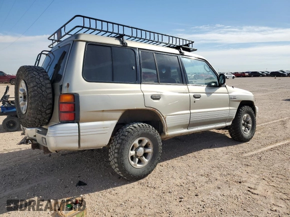 1998 Mitsubishi Montero z VIN JA4MR51R0WJ000921, wystawiony jako Copart lot #56250965 z przebiegiem 181 293 mil mil oraz Szkoda całkowita • Salvage title. Historia ofert i sprzedaży dostępna na DreamBid. Obrazek 3.