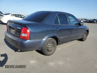 1999 Mazda Protege DX z VIN JM1BJ2227X0106522, wystawiony jako Copart lot #52423565 z przebiegiem 206 260 mil mil oraz Szkoda całkowita • Salvage title. Historia ofert i sprzedaży dostępna na DreamBid. Obrazek 3.