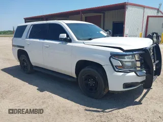 2015 Chevrolet Tahoe Commercial z VIN 1GNLC2ECXFR673084, wystawiony jako IAAI lot #41881353 z przebiegiem 256 096 mil mil oraz . Historia ofert i sprzedaży dostępna na DreamBid. Obrazek 1.