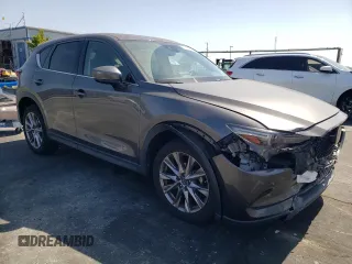 2019 Mazda CX-5 Grand Touring with VIN JM3KFADM6K1641992, listed as a Copart auction lot 57862345 with 37,100 mi miles and Salvage title. Bid and sale history available at DreamBid. Image 4.