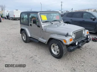 2001 Jeep Wrangler Sport z VIN 1J4FA49S31P349269, wystawiony jako IAAI lot #41427014 z przebiegiem 112 421 mil mil oraz . Historia ofert i sprzedaży dostępna na DreamBid. Obrazek 1.