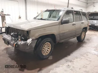 1996 Jeep Grand Cherokee Laredo with VIN 1J4GZ58S5TC182766, listed as a IAAI auction lot 41372356 with 234,390 mi miles. Bid and sale history available at carsss.com. Image 2.
