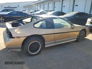 1987 Pontiac Fiero GT z VIN 1G2PG119XHP200243, wystawiony jako Copart lot #74389864 z przebiegiem 109 478 mil mil oraz Tytuł czysty. Historia ofert i sprzedaży dostępna na DreamBid. Obrazek 3.