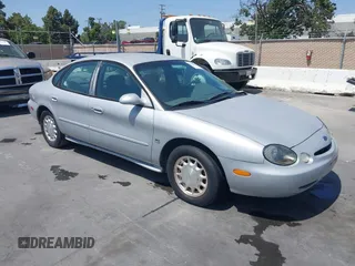 1996 Ford Taurus LX z VIN 1FALP53S5TG199843, wystawiony jako IAAI lot #42430761 z przebiegiem 95 984 mil mil oraz . Historia ofert i sprzedaży dostępna na DreamBid. Obrazek 1.