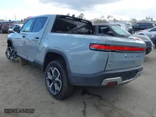 2023 Rivian R1T Adventure with VIN 7FCTGBAA9PN027894, listed as a IAAI auction lot 42061339 with 5,047 mi miles. Bid and sale history available at carsss.com. Image 3.