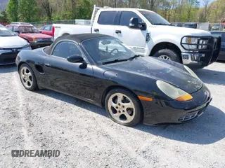1999 Porsche Boxster z VIN WP0CA2980XU624284, wystawiony jako IAAI lot #42058935 z przebiegiem 79 497 mil mil oraz . Historia ofert i sprzedaży dostępna na DreamBid. Obrazek 1.