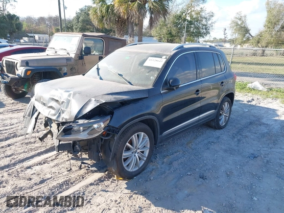 2012 Volkswagen Tiguan SE with VIN WVGAV7AX8CW565863, listed as a IAAI auction lot 41528643 with 122,569 mi miles and . Bid and sale history available at DreamBid. Image 2.