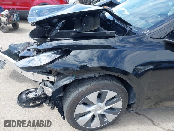 2023 Tesla Model Y Long Range z VIN 7SAYGDEE2PF863200, wystawiony jako IAAI lot #41805168 z przebiegiem 25 480 mil mil oraz . Historia ofert i sprzedaży dostępna na DreamBid. Obrazek 21.