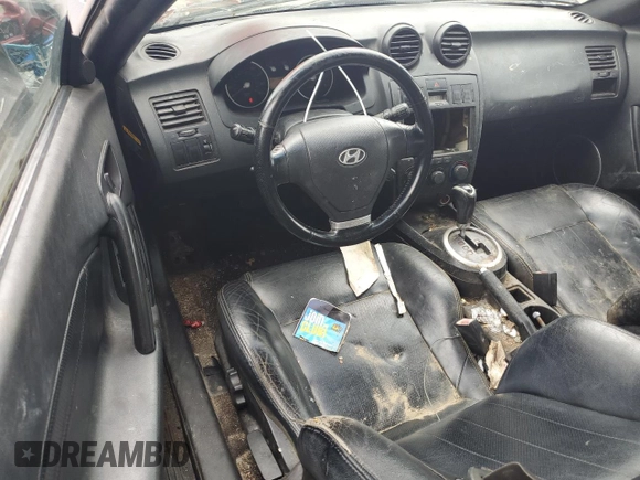 2003 Hyundai Tiburon GT z VIN KMHHN65F83U101784, wystawiony jako Copart lot #41566805 z przebiegiem 99 970 mil mil oraz Nie do naprawy • Non repairable. Historia ofert i sprzedaży dostępna na DreamBid. Obrazek 8.