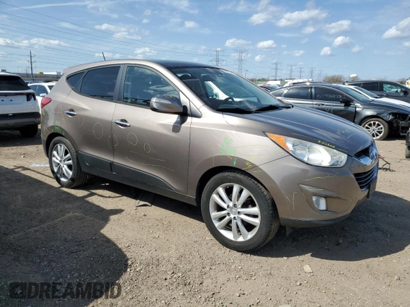 2010 Hyundai Tucson GLS with VIN KM8JU3AC8AU056499, listed as a Copart auction lot 53057365 with 119,906 mi miles and Salvage Title. Bid and sale history available at DreamBid. Image 4.