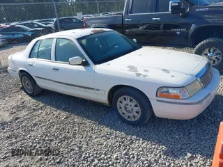 2004 Mercury Grand Marquis GS z VIN 2MEFM74W74X654151, wystawiony jako IAAI lot #42185493 z przebiegiem 203 017 mil mil oraz . Historia ofert i sprzedaży dostępna na DreamBid. Obrazek 1.
