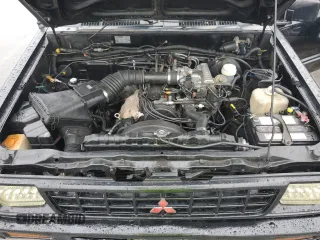 1991 Mitsubishi Mighty Max z VIN JA7FL25W7MP028365, wystawiony jako Copart lot #43964285 z przebiegiem 175 102 mil mil oraz Szkody całkowita. Historia ofert i sprzedaży dostępna na DreamBid. Obrazek 11.