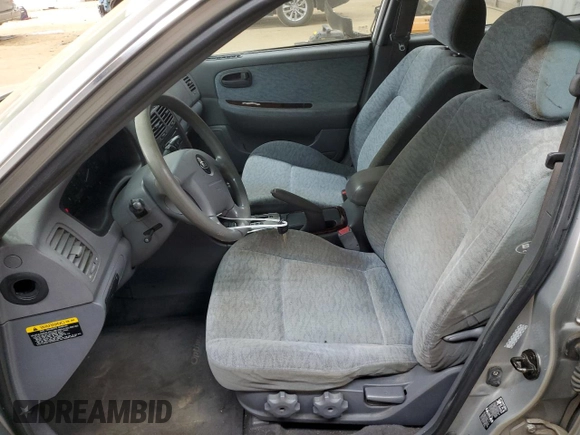 2005 Kia Optima LX z VIN KNAGD128155423463, wystawiony jako Copart lot #87441284 z przebiegiem 143 193 mil mil oraz Szkoda całkowita • Salvage title. Historia ofert i sprzedaży dostępna na DreamBid. Obrazek 7.