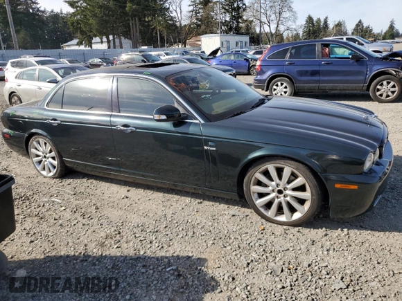 2008 Jaguar XJ with VIN SAJWA79BX8SH23430, listed as a Copart auction lot 51990785 with 140,454 mi miles and Salvage Title. Bid and sale history available at carsss.com. Image 4.