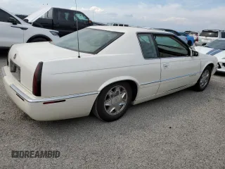 1999 Cadillac Eldorado z VIN 1G6EL12Y7XU615169, wystawiony jako Copart lot #76459744 z przebiegiem Nie podano mil oraz Szkoda całkowita • Salvage title. Historia ofert i sprzedaży dostępna na DreamBid. Obrazek 3.