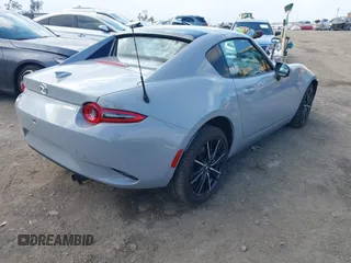 2024 Mazda MX-5 Miata Grand Touring z VIN JM1NDAM76R0602860, wystawiony jako IAAI lot #41346197 z przebiegiem 1 891 mil mil oraz . Historia ofert i sprzedaży dostępna na DreamBid. Obrazek 4.