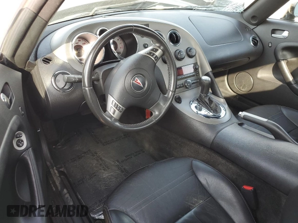 2007 Pontiac Solstice z VIN 1G2MB35B97Y117728, wystawiony jako Copart lot #87267724 z przebiegiem Nie podano mil oraz Szkoda całkowita • Salvage title. Historia ofert i sprzedaży dostępna na DreamBid. Obrazek 8.