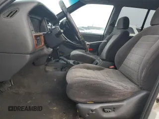 1998 Jeep Grand Cherokee Laredo with VIN 1J4GZ48S1WC165851, listed as a Copart auction lot 84110044 with 306,484 mi miles and Salvage Title. Bid and sale history available at carsss.com. Image 7.