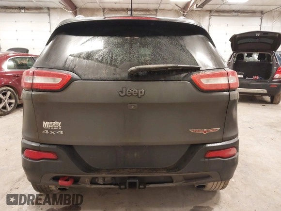 2014 Jeep Cherokee Trailhawk with VIN 1C4PJMBS2EW231813, listed as a IAAI auction lot 41664287 with 128,893 mi miles. Bid and sale history available at carsss.com. Image 16.