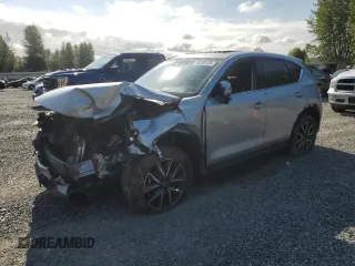 2018 Mazda CX-5 Grand Touring with VIN JM3KFBDM5J0323923, listed as a Copart auction lot 58162435 with 144,792 mi miles and Salvage title. Bid and sale history available at DreamBid. Image 1.
