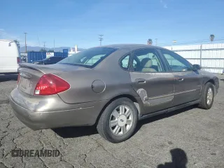 2003 Ford Taurus SEL Deluxe with VIN 1FAFP56S23G221922, listed as a Copart auction lot 79673294 with 142,911 mi miles and Salvage Title. Bid and sale history available at DreamBid. Image 3.