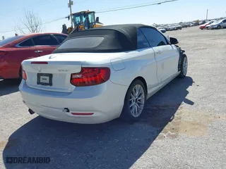 2015 BMW 2 Series 228i with VIN WBA1K5C50FV474011, listed as a IAAI auction lot 41805879 with 83,489 mi miles. Bid and sale history available at carsss.com. Image 4.