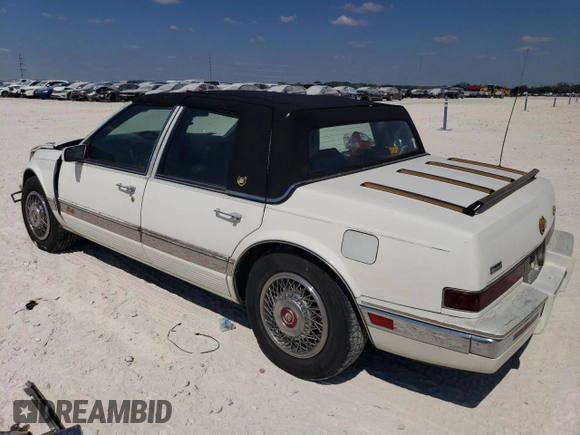 1991 Cadillac Seville z VIN 1G6KS53B9MU824142, wystawiony jako Copart lot #74276264 z przebiegiem 103 517 mil mil oraz Szkody całkowita. Historia ofert i sprzedaży dostępna na DreamBid. Obrazek 2.