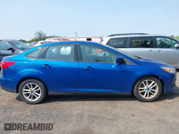 2018 Ford Focus SE z VIN 1FADP3FE1JL254632, wystawiony jako IAAI lot #42408683 z przebiegiem 74 696 mil mil oraz . Historia ofert i sprzedaży dostępna na DreamBid. Obrazek 13.