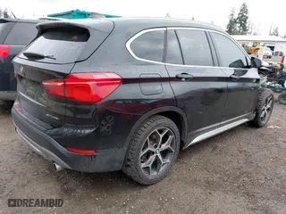 2018 BMW X1 xDrive28i with VIN WBXHT3C39J3H30531, listed as a IAAI auction lot 41890734 with 59,147 mi miles. Bid and sale history available at carsss.com. Image 4.