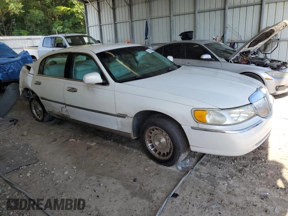 1999 Lincoln Town Car Executive with VIN 1LNHM81W2XY658371, listed as a Copart auction lot 60249045 with 191,266 mi miles and Salvage title. Bid and sale history available at DreamBid. Image 4.