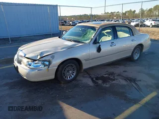 2001 Lincoln Town Car Cartier z VIN 1LNHM83W21Y621003, wystawiony jako IAAI lot #41291516 z przebiegiem 145 455 mil mil oraz . Historia ofert i sprzedaży dostępna na DreamBid. Obrazek 2.