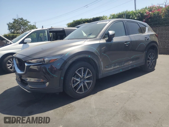 2018 Mazda CX-5 Grand Touring with VIN JM3KFADM3J1389911, listed as a Copart auction lot 60530295 with 103,177 mi miles and Salvage title. Bid and sale history available at DreamBid. Image 1.