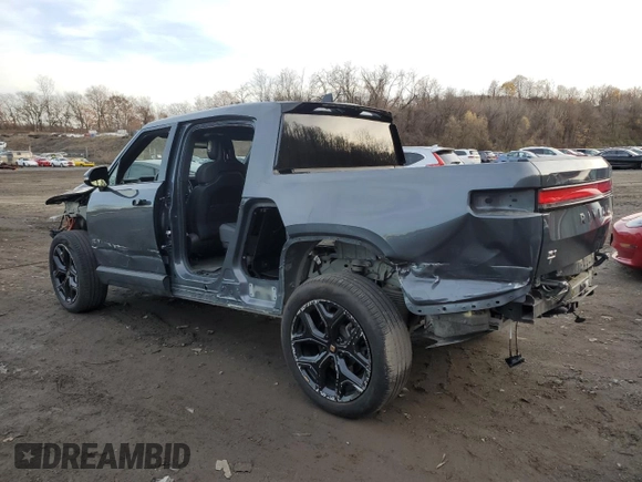 2023 Rivian R1T Adventure z VIN 7FCTGBAA8PN028065, wystawiony jako Copart lot #81941474 z przebiegiem 16 060 mil mil oraz Szkoda całkowita • Salvage title. Historia ofert i sprzedaży dostępna na DreamBid. Obrazek 2.