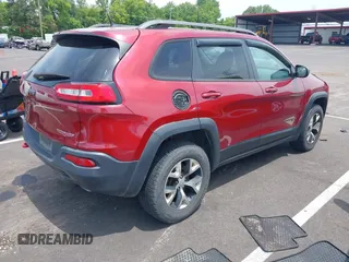 2014 Jeep Cherokee Trailhawk with VIN 1C4PJMBS7EW162357, listed as a IAAI auction lot 42601903 with 104,768 mi miles and . Bid and sale history available at DreamBid. Image 4.