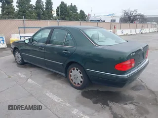 1997 Mercedes-Benz E-Class with VIN WDBJF55F3VJ034009, listed as a IAAI auction lot 41710225 with 239,673 mi miles. Bid and sale history available at carsss.com. Image 3.