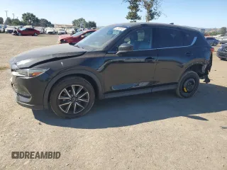 2018 Mazda CX-5 Grand Touring z VIN JM3KFADM2J1310339, wystawiony jako Copart lot #64705245 z przebiegiem 63 927 mil mil oraz Szkoda całkowita • Salvage title. Historia ofert i sprzedaży dostępna na DreamBid. Obrazek 1.