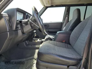 2000 Jeep Cherokee with VIN 1J4FT48S6YL152495, listed as a Copart auction lot 60627965 with 196,086 mi miles and Salvage title. Bid and sale history available at DreamBid. Image 7.