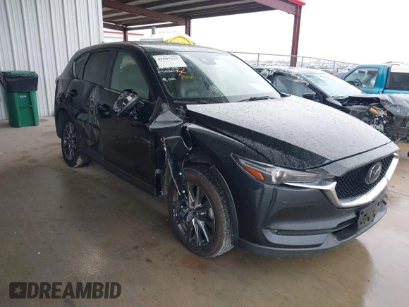 2021 Mazda CX-5 Signature with VIN JM3KFBEY5M0432033, listed as a IAAI auction lot 41607215 with 49,870 mi miles. Bid and sale history available at carsss.com. Image 1.