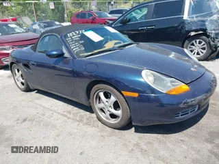 2000 Porsche Boxster z VIN WP0CA298XYU624469, wystawiony jako IAAI lot #41997950 z przebiegiem 89 421 mil mil oraz . Historia ofert i sprzedaży dostępna na DreamBid. Obrazek 1.