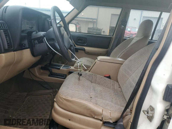 2000 Jeep Cherokee with VIN 1J4FF48S1YL174377, listed as a Copart auction lot 50032345 with 204,234 mi miles and Salvage title. Bid and sale history available at DreamBid. Image 7.