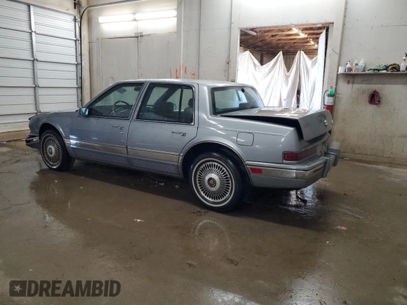 1991 Cadillac Seville z VIN 1G6KS53B2MU809384, wystawiony jako Copart lot #77185134 z przebiegiem 134 769 mil mil oraz Szkody całkowita. Historia ofert i sprzedaży dostępna na DreamBid. Obrazek 2.