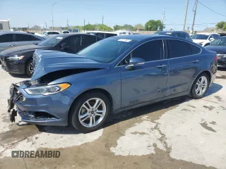 2018 Ford Fusion SE z VIN 3FA6P0HD7JR180095, wystawiony jako Copart lot #55980745 z przebiegiem 76 994 mil mil oraz Czysty tytuł • Clean title. Historia ofert i sprzedaży dostępna na DreamBid. Obrazek 1.