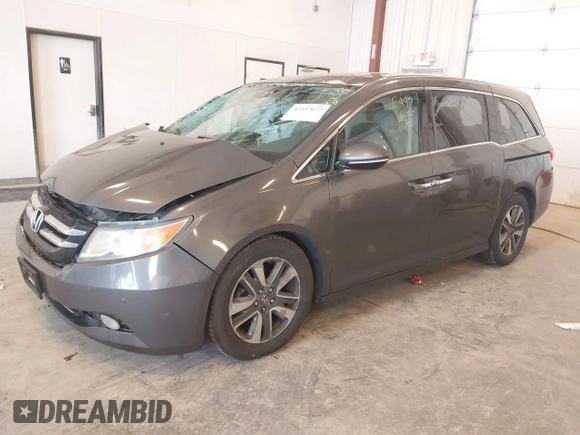 2014 Honda Odyssey Touring with VIN 5FNRL5H99EB105059, listed as a IAAI auction lot 42457672 with 240,581 mi miles and . Bid and sale history available at DreamBid. Image 2.