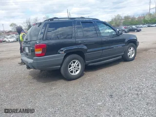 2003 Jeep Grand Cherokee Laredo with VIN 1J8GW48S63C596866, listed as a IAAI auction lot 42060430 with 129,849 mi miles. Bid and sale history available at carsss.com. Image 4.