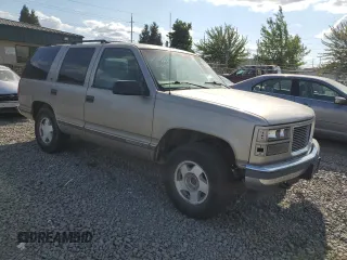 1999 GMC Yukon with VIN 1GKEK13R9XJ740395, listed as a Copart auction lot 83801394 with 185,305 mi miles and Salvage Title. Bid and sale history available at carsss.com. Image 4.
