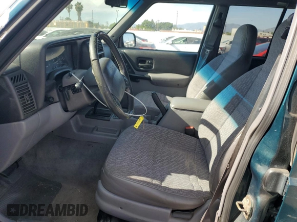 1997 Jeep Cherokee Sport with VIN 1J4FT68S4VL545385, listed as a Copart auction lot 49616325 with 239,798 mi miles and Salvage Title. Bid and sale history available at carsss.com. Image 7.